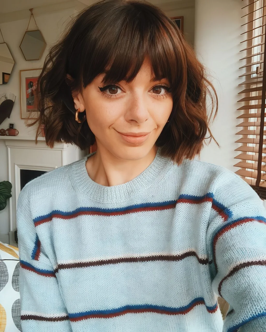 Short brunette bob with waves and bangs.