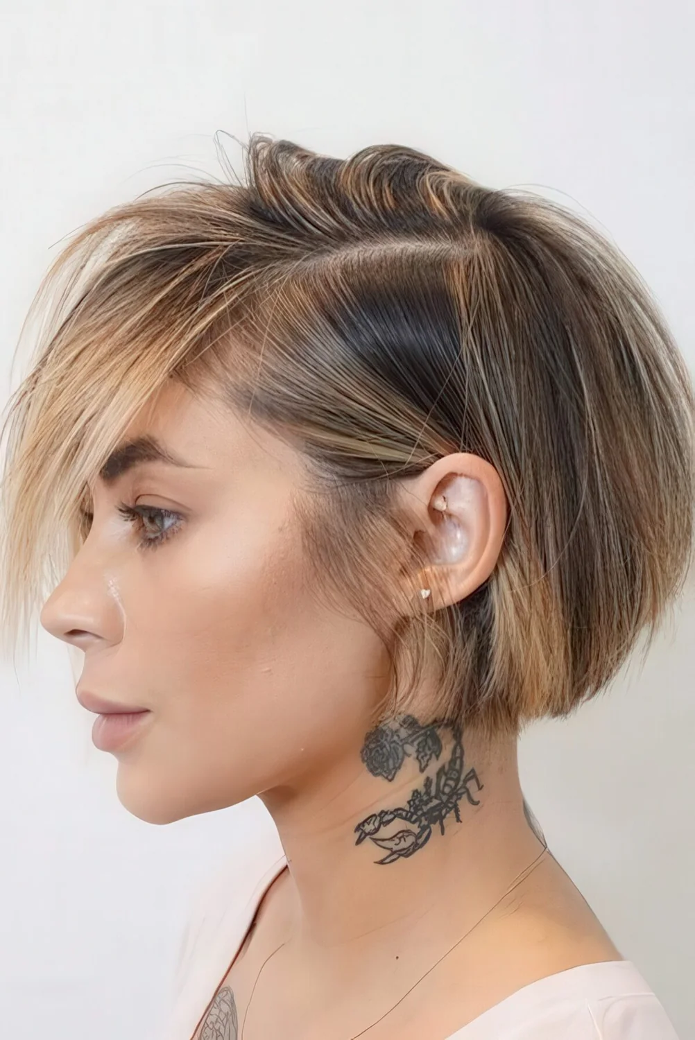 Straight short bob with blonde balayage including face-framing highlights.