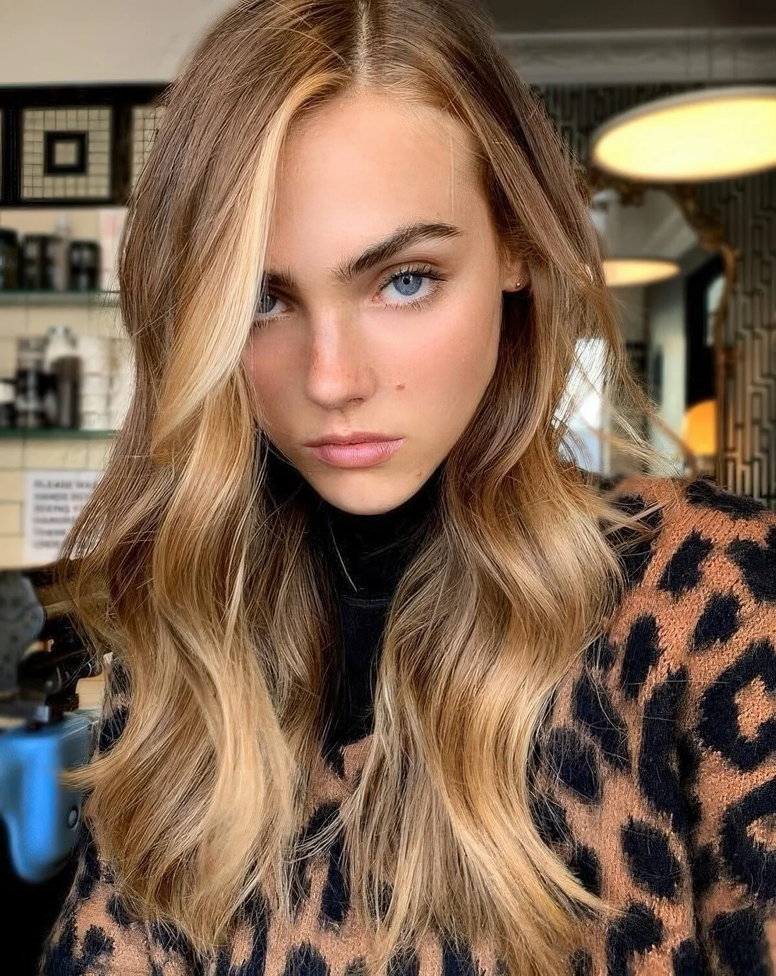 Light brunette hair with sunkissed locks framing the face.