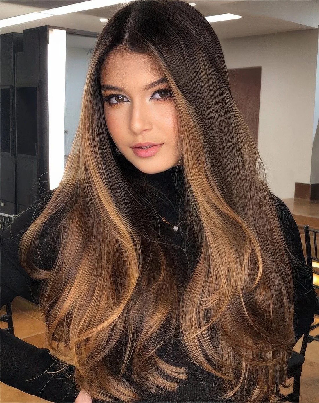 Long straight brunette hair with wide caramel face-framing panels.