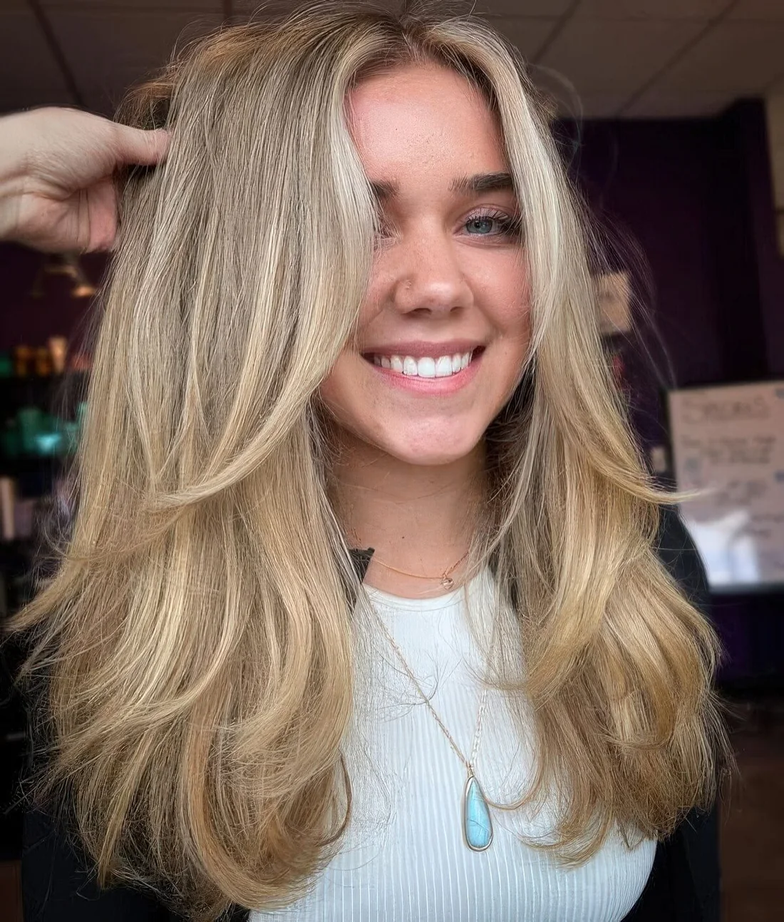 Fab long blonde hair cut in layers including face-framing ones, with center part.