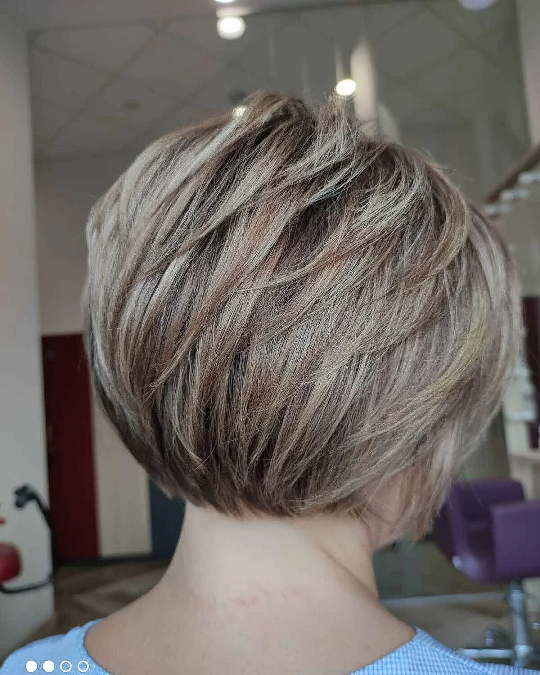 Photo showing feathered bob with piecey layers, with the hairstyle clearly visible.