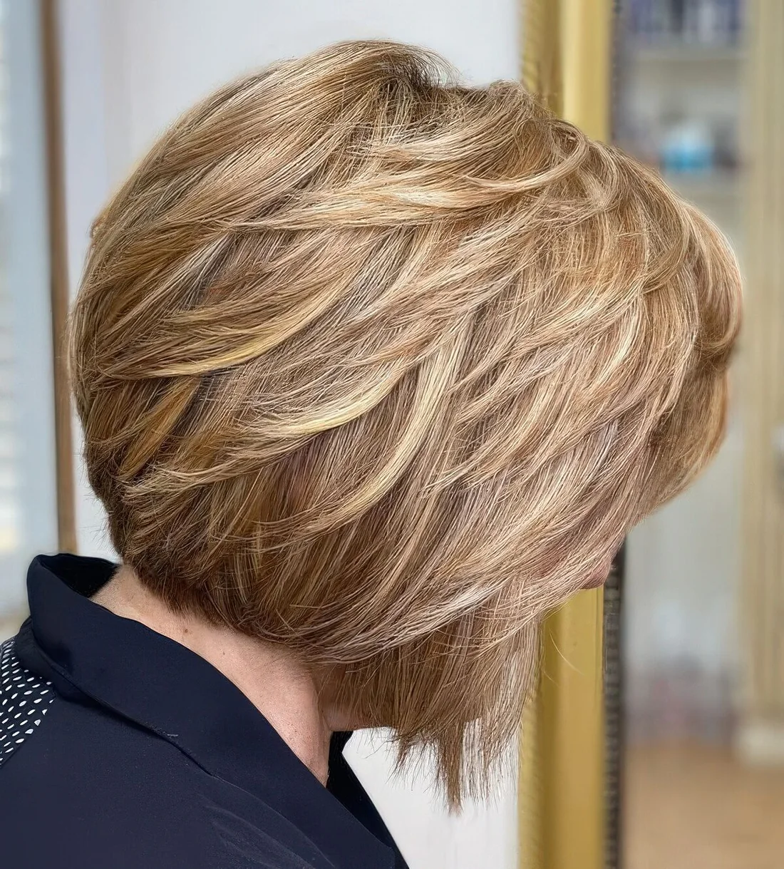 Feathered jaw ling bob with blonde balayage.