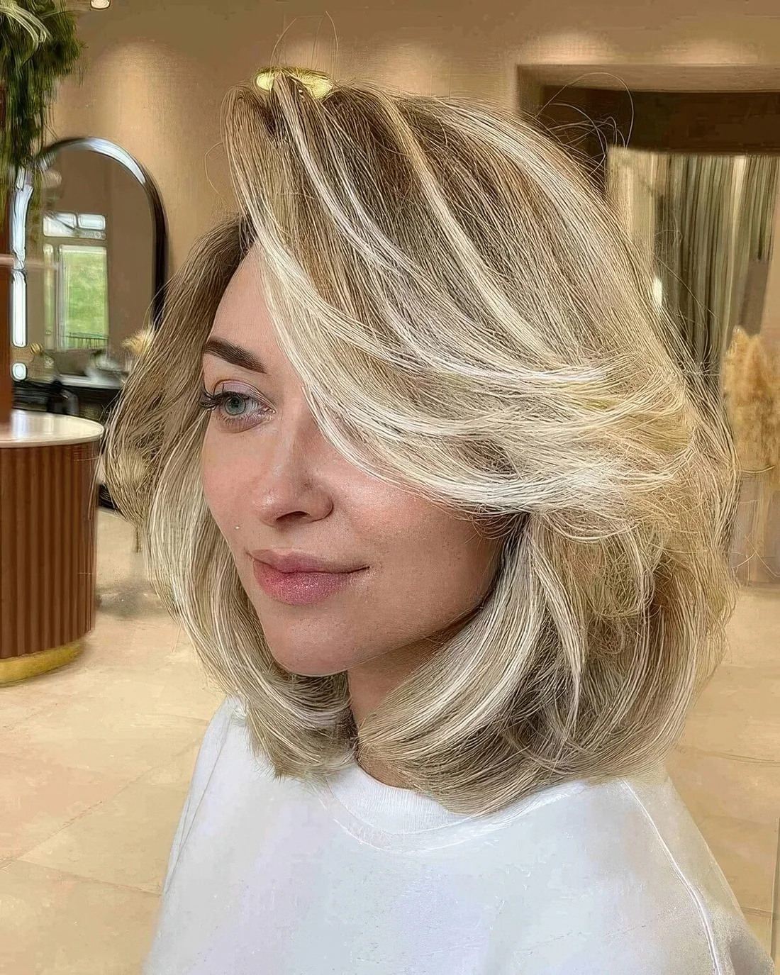 Feathered long bob with blonde balayage and a lot of movement.