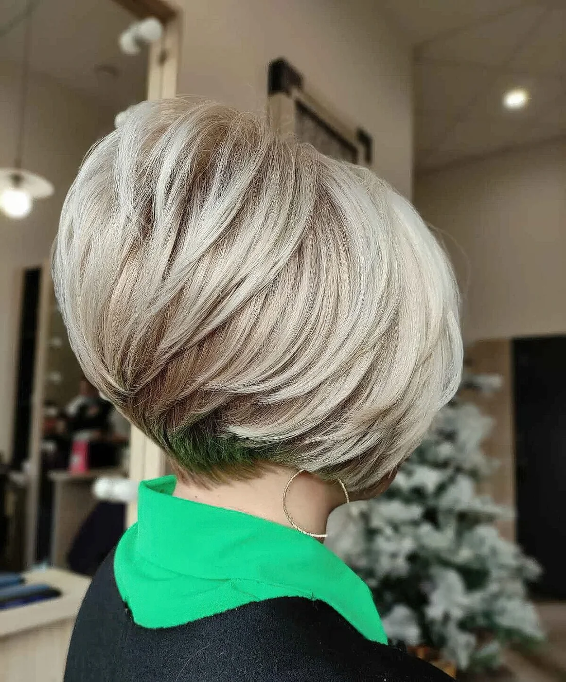 Photo showing tapered bob with feathered pieces, with the hairstyle clearly visible.