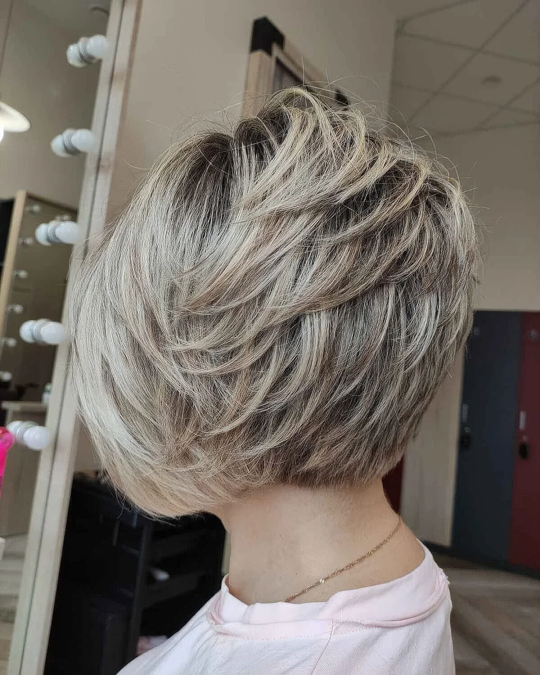 Textured feathered bob haircut with soft choppy layers.