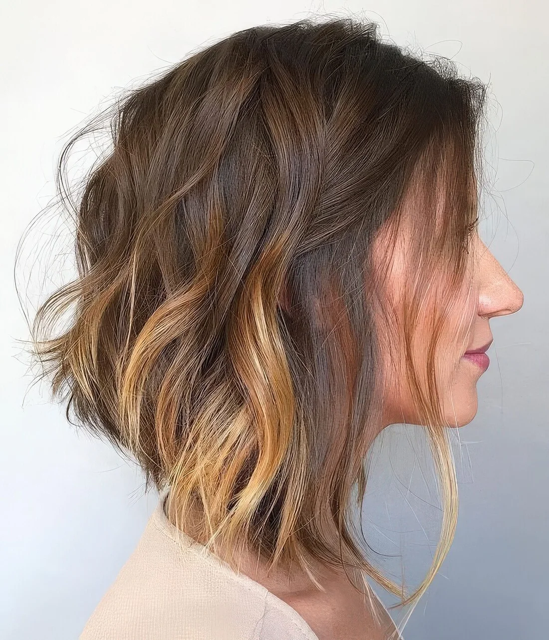 Photo showing long angled bob with messy waves, with the hairstyle clearly visible.