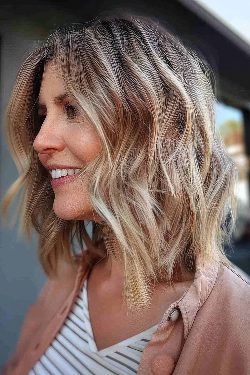 Tousled wave lob with a sun faded balayage.