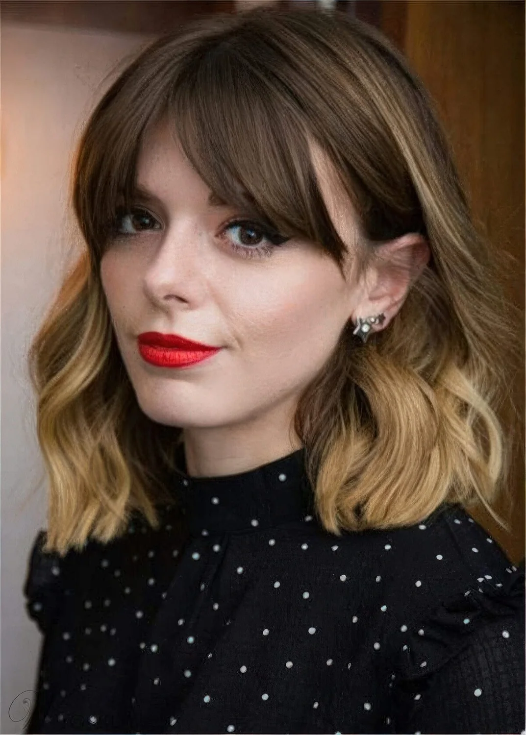Mid length haircut with an ombre effect and waves.