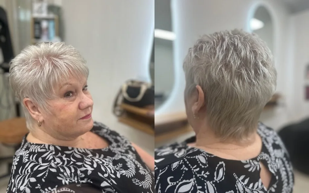 Short silver pixie with fine feathered texture and a soft tapered neckline.