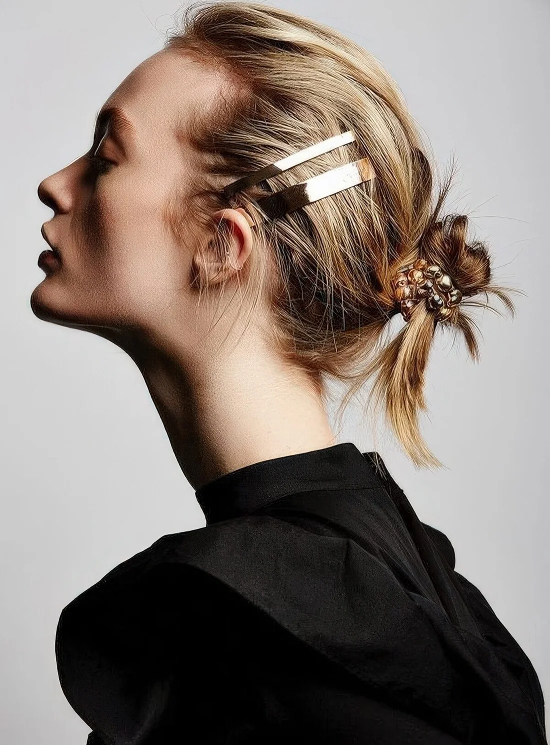 Photo showing messy midi bun, with the hairstyle clearly visible.
