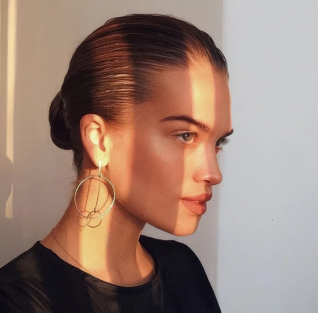 Photo showing sleek low bun, with the hairstyle clearly visible.