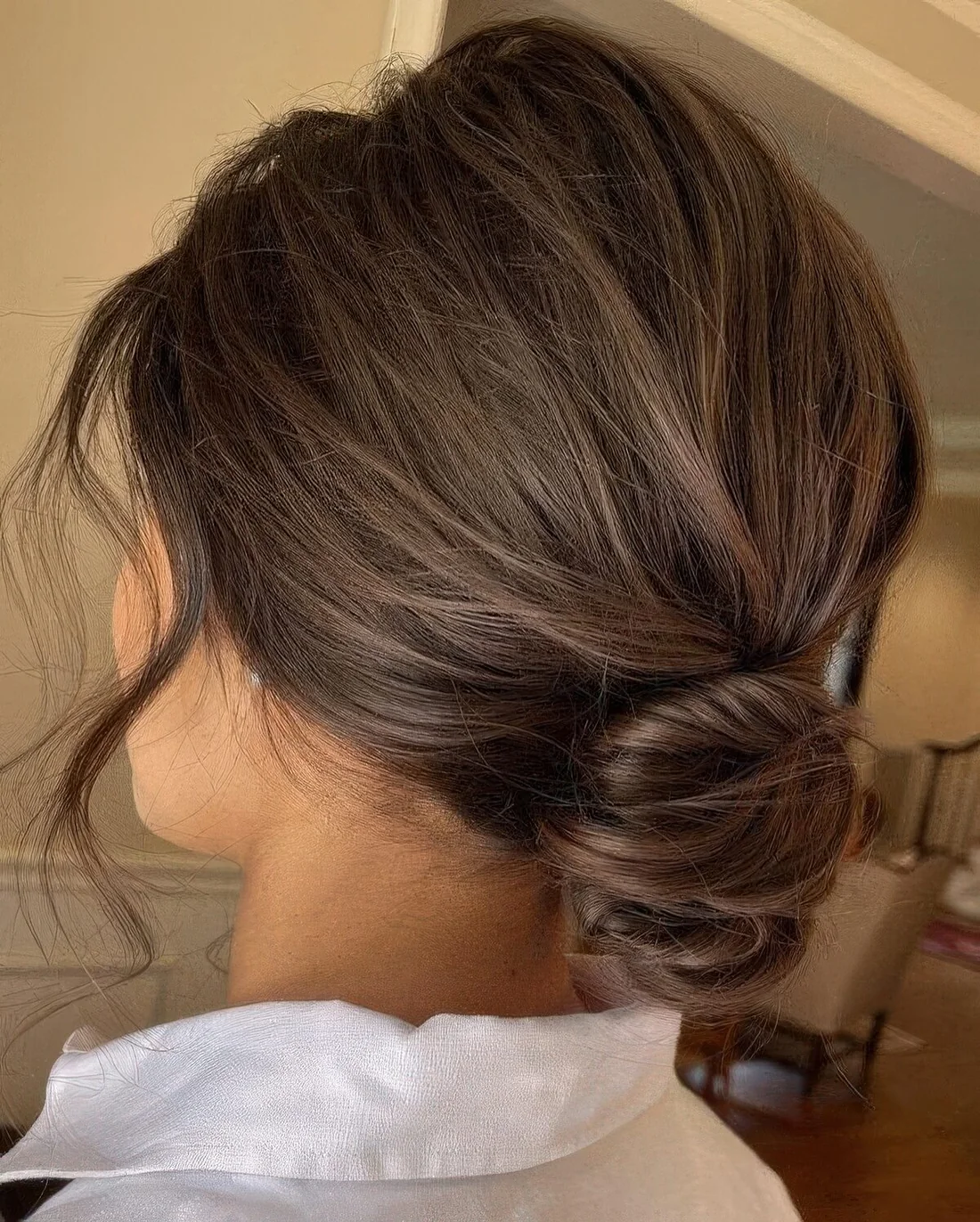 Photo showing low messy bun, with the hairstyle clearly visible.