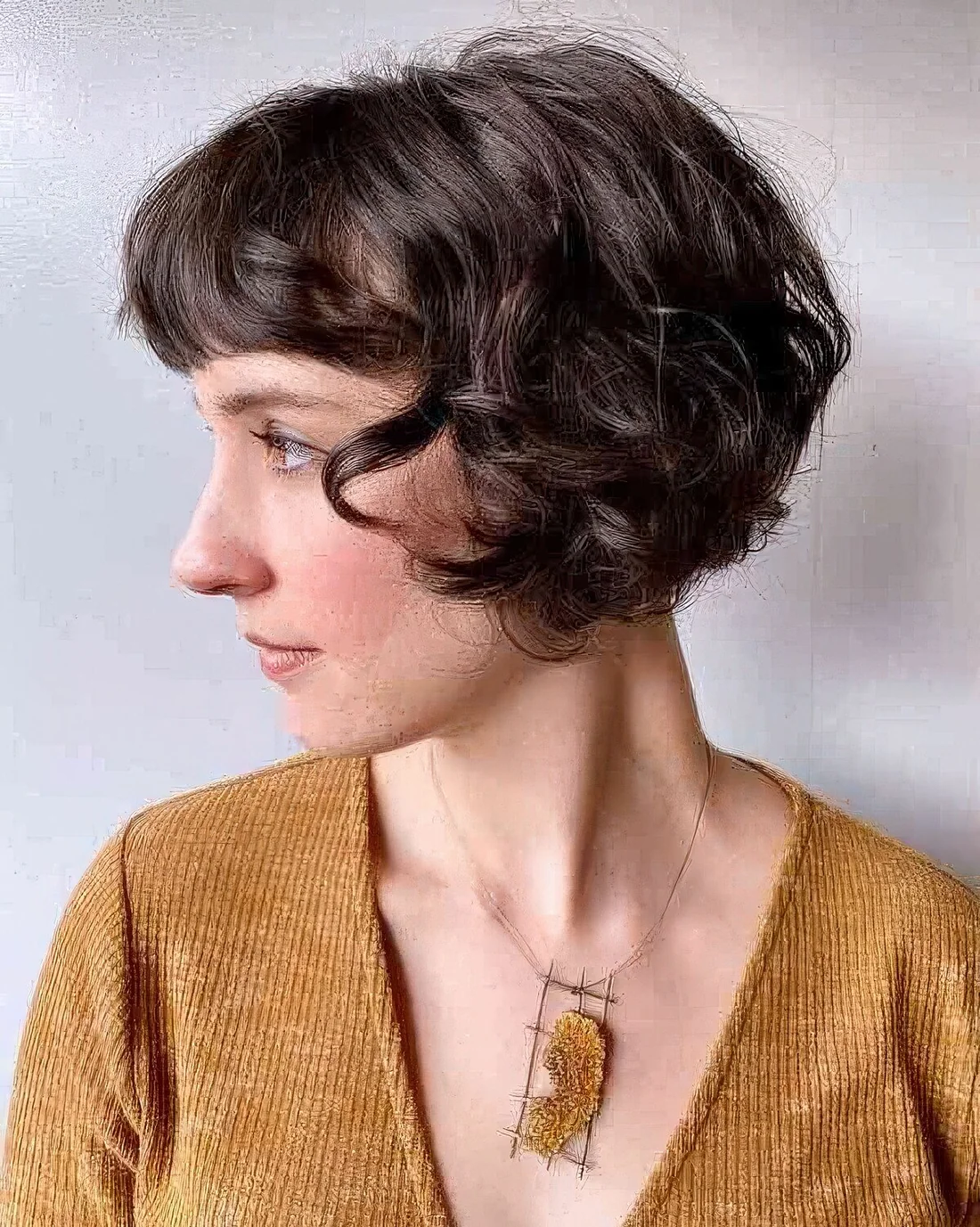 Curly French bob with soft, tousled curls.