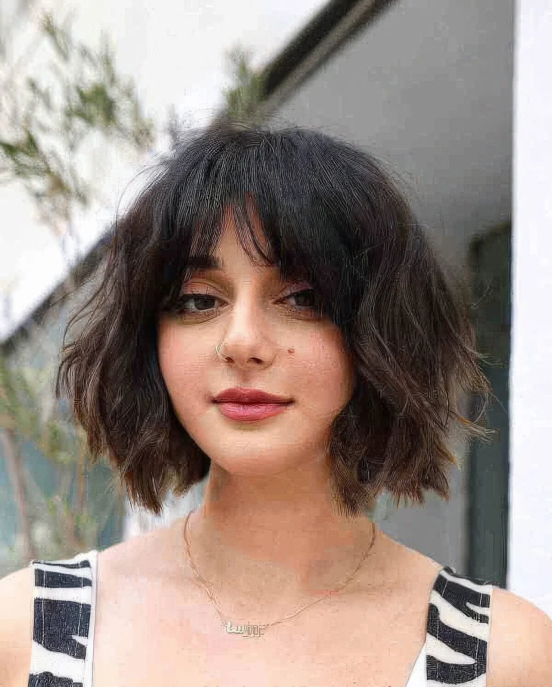 Lived in French bob in black and light brown with a lot of texture and bottleneck bangs.