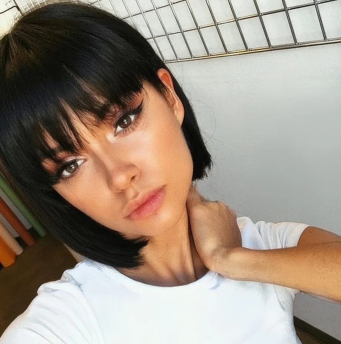 Black French bob with bangs for a super cute, doll like look.