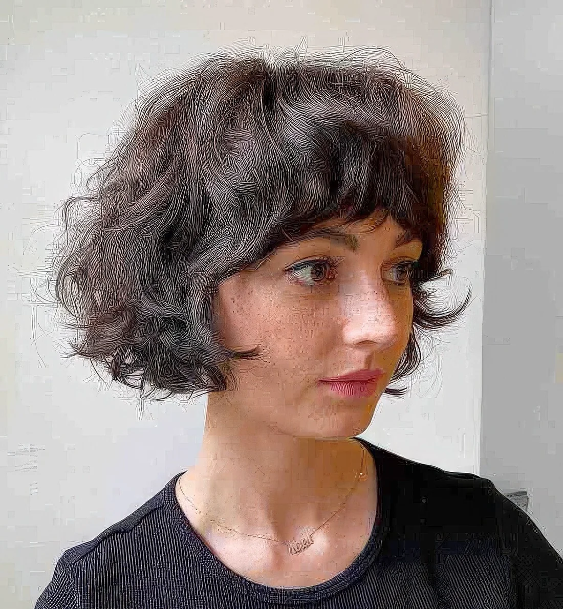Photo showing messy wavy French bob, with the hairstyle clearly visible.