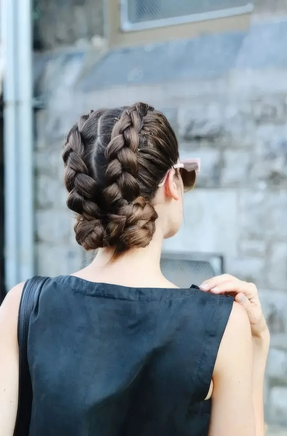 Two voluminous French braids with large low buns are a catchy and bold solution for some occasion or party.