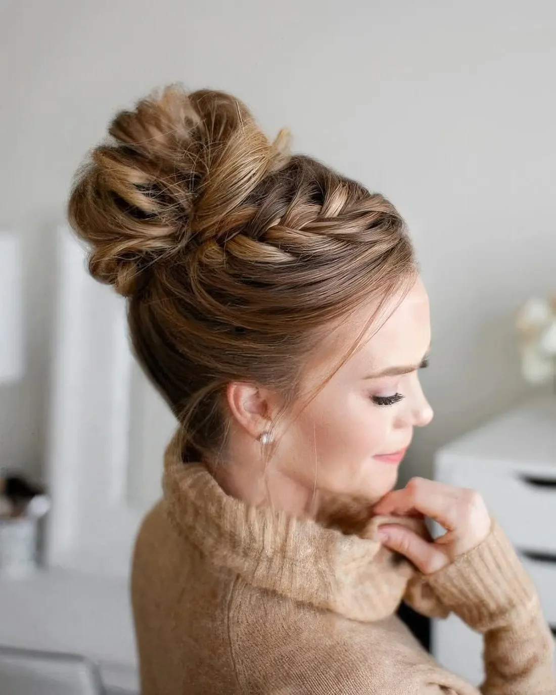 Whimsical updo with a French braid on top and a wavy top knot.