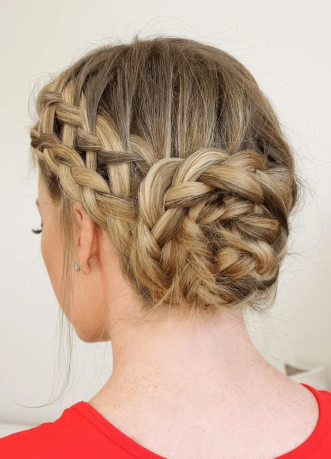 Updo with a double French braid halo into a midi bun.