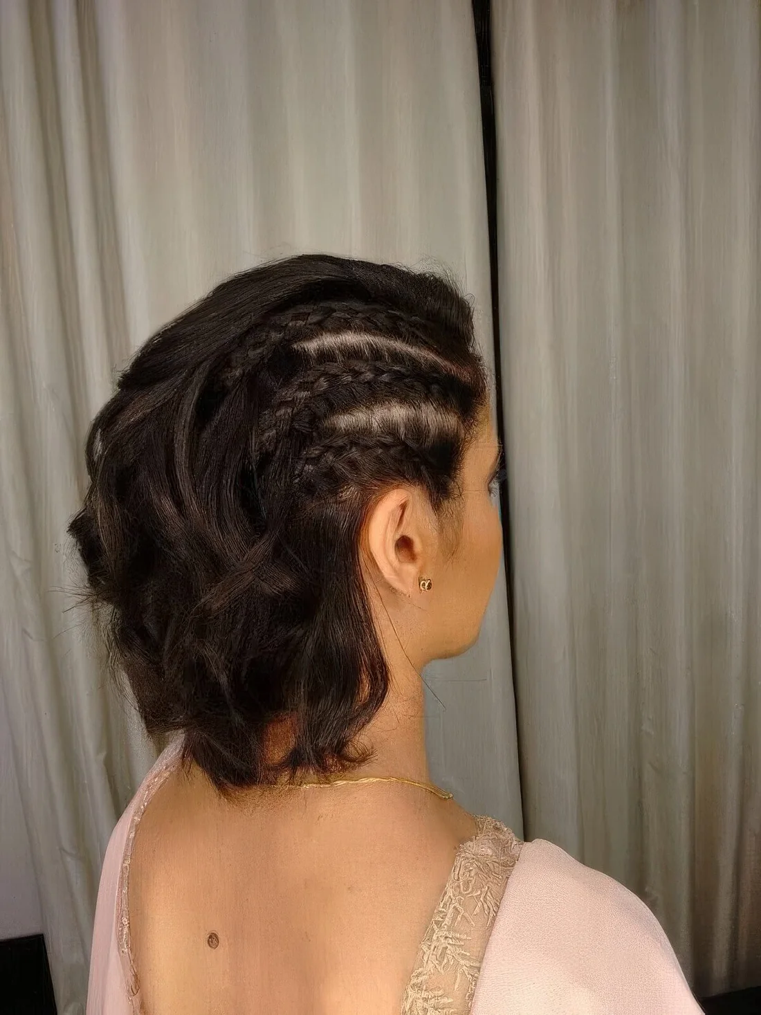 Medium hair half updo with a series of side French braids and waves down.