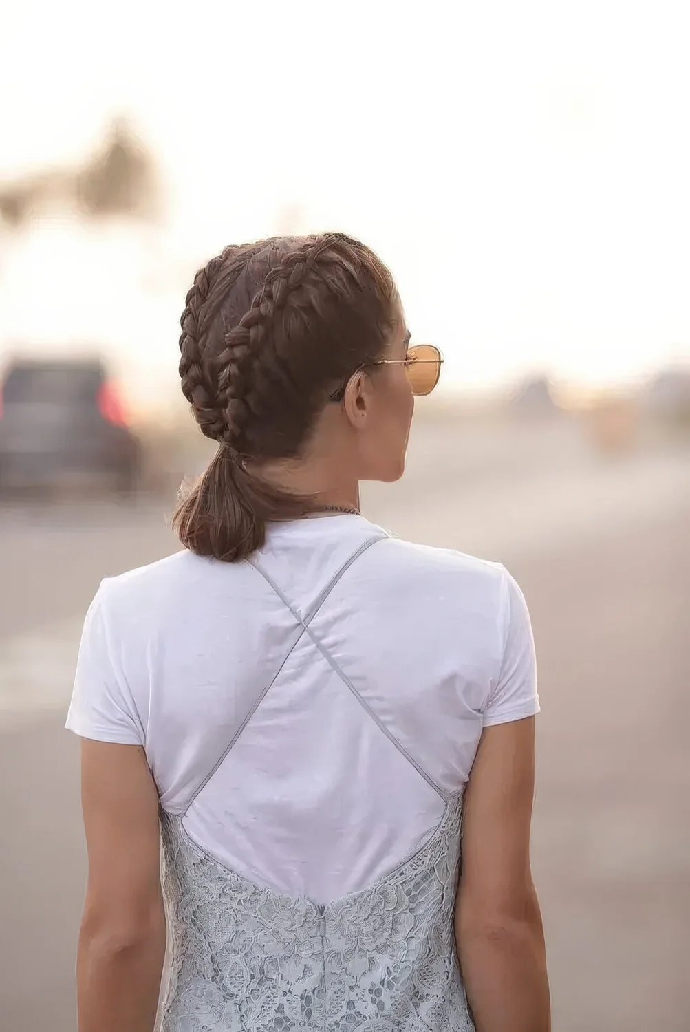 Hairstyle with two French braids ending up in a single ponytail.