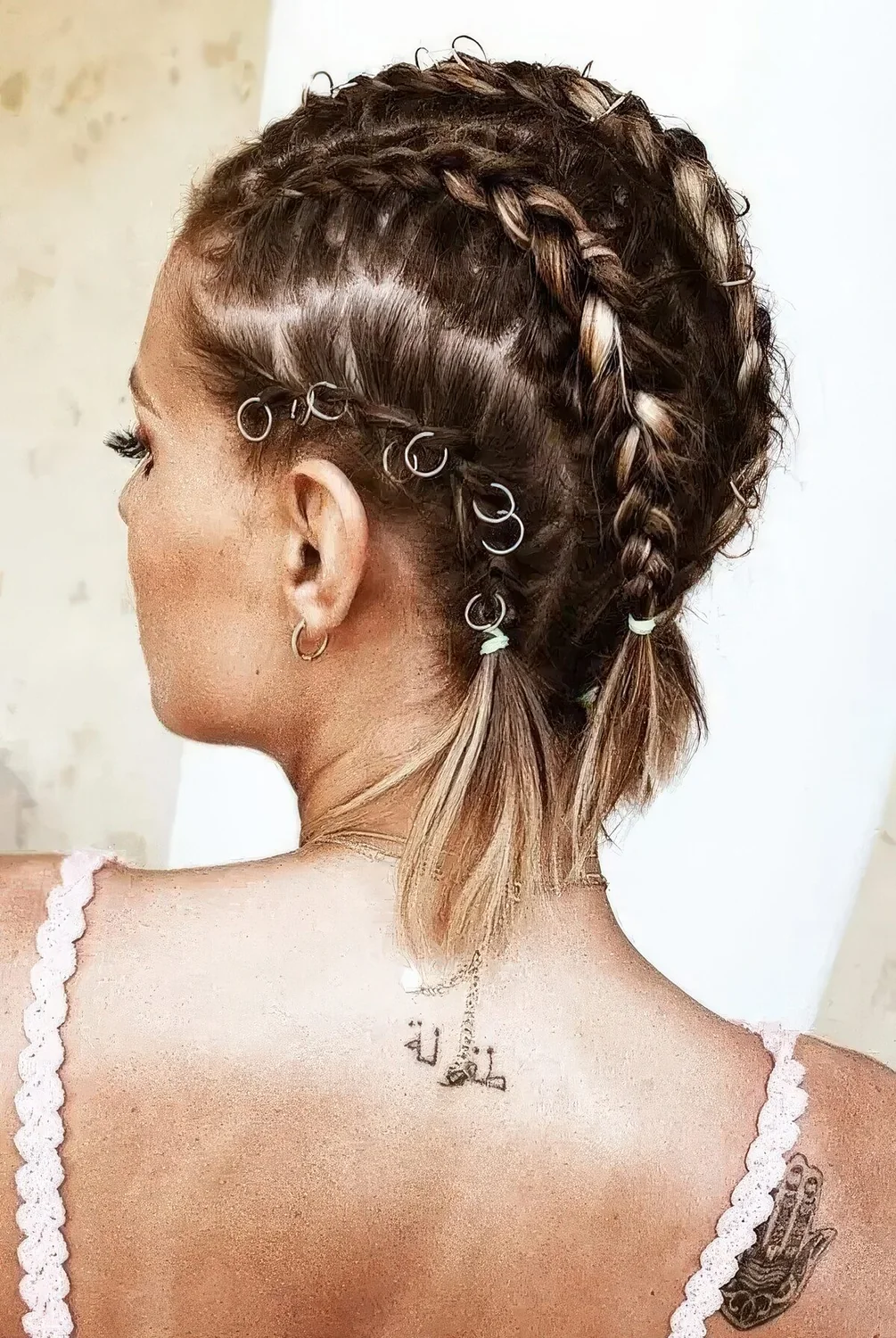 Midi bob styled with several braids done with hair piercings.