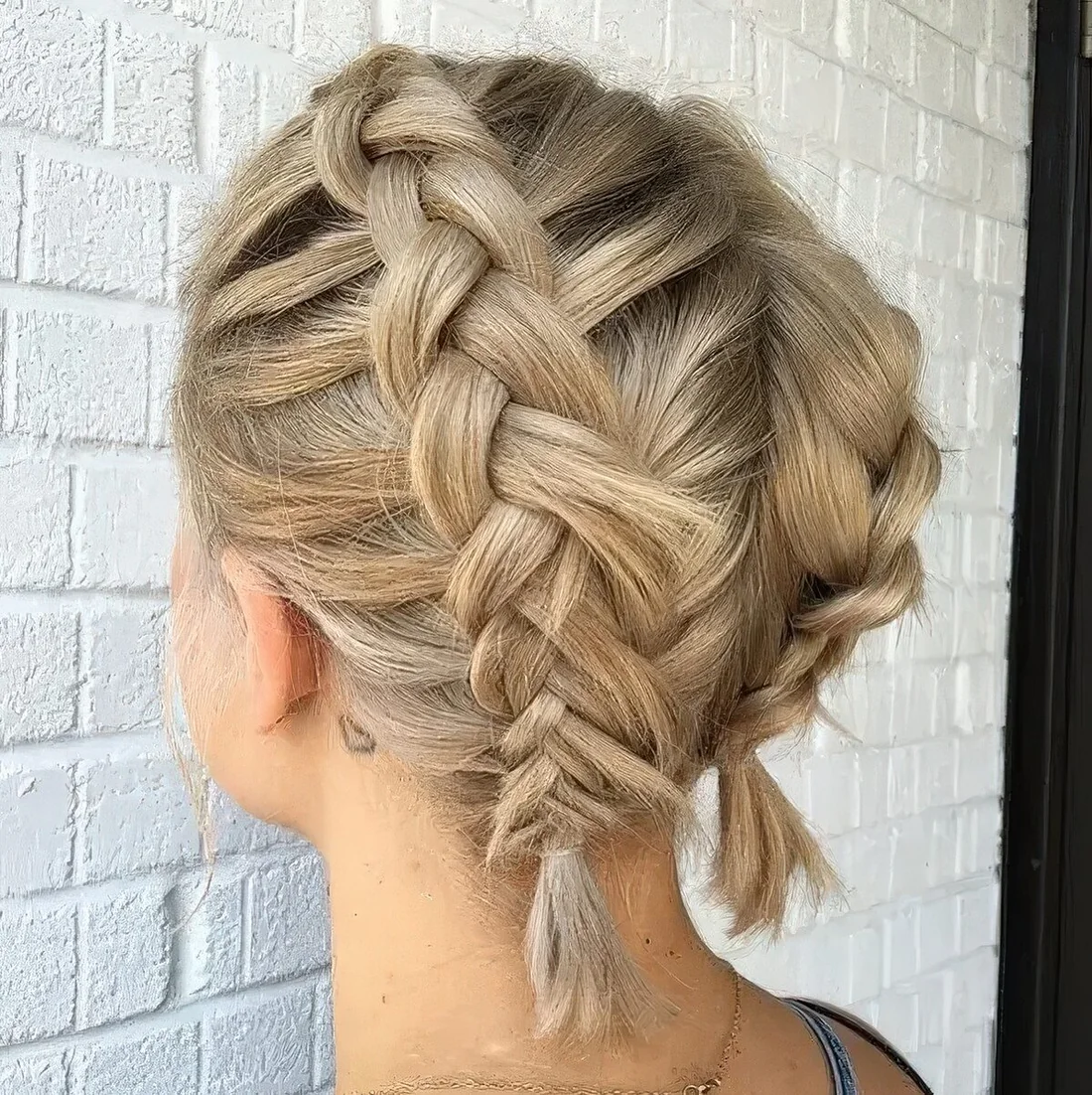 Short blonde bob with two braids on top.