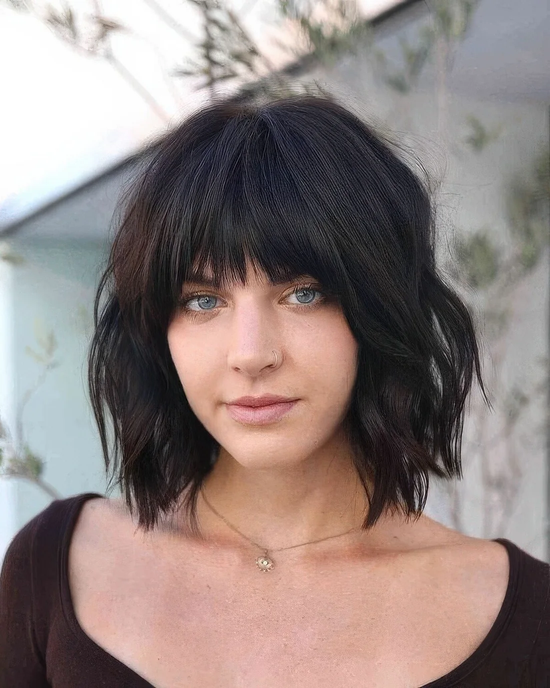 Black choppy bob with fringe bangs and waves.