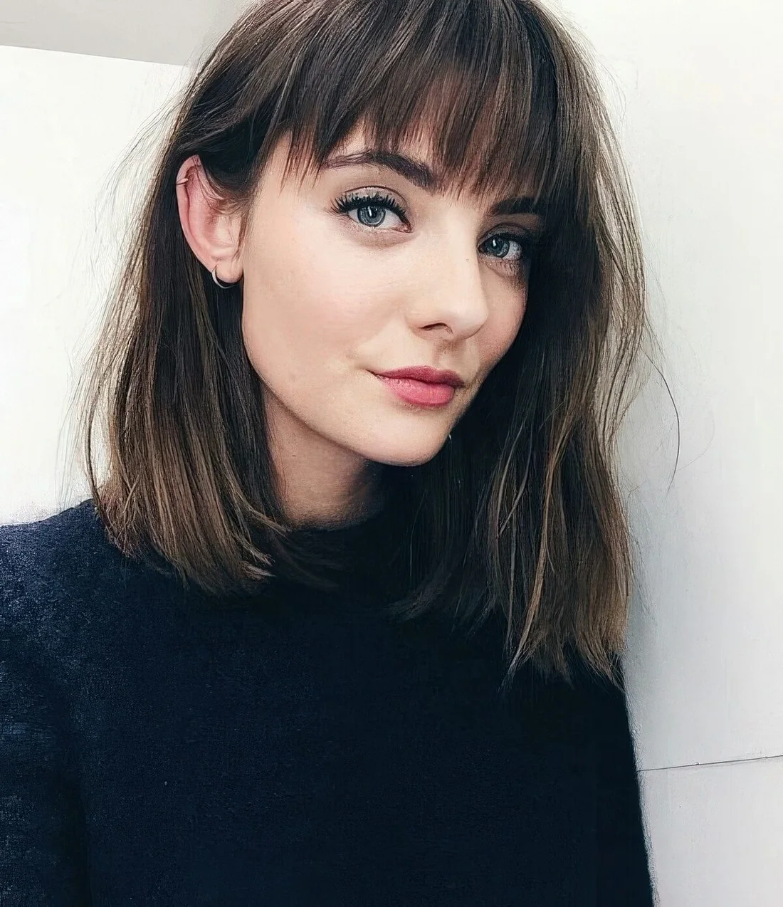 Chic brown lob with highlights and chic messy Birkin bangs.