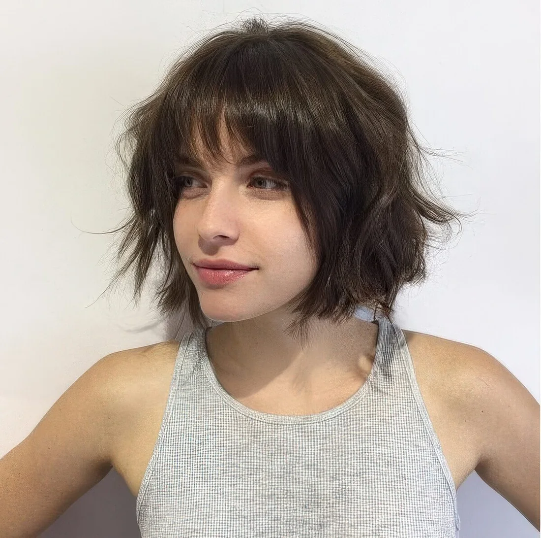Photo showing choppy short bob with bangs, with the hairstyle clearly visible.