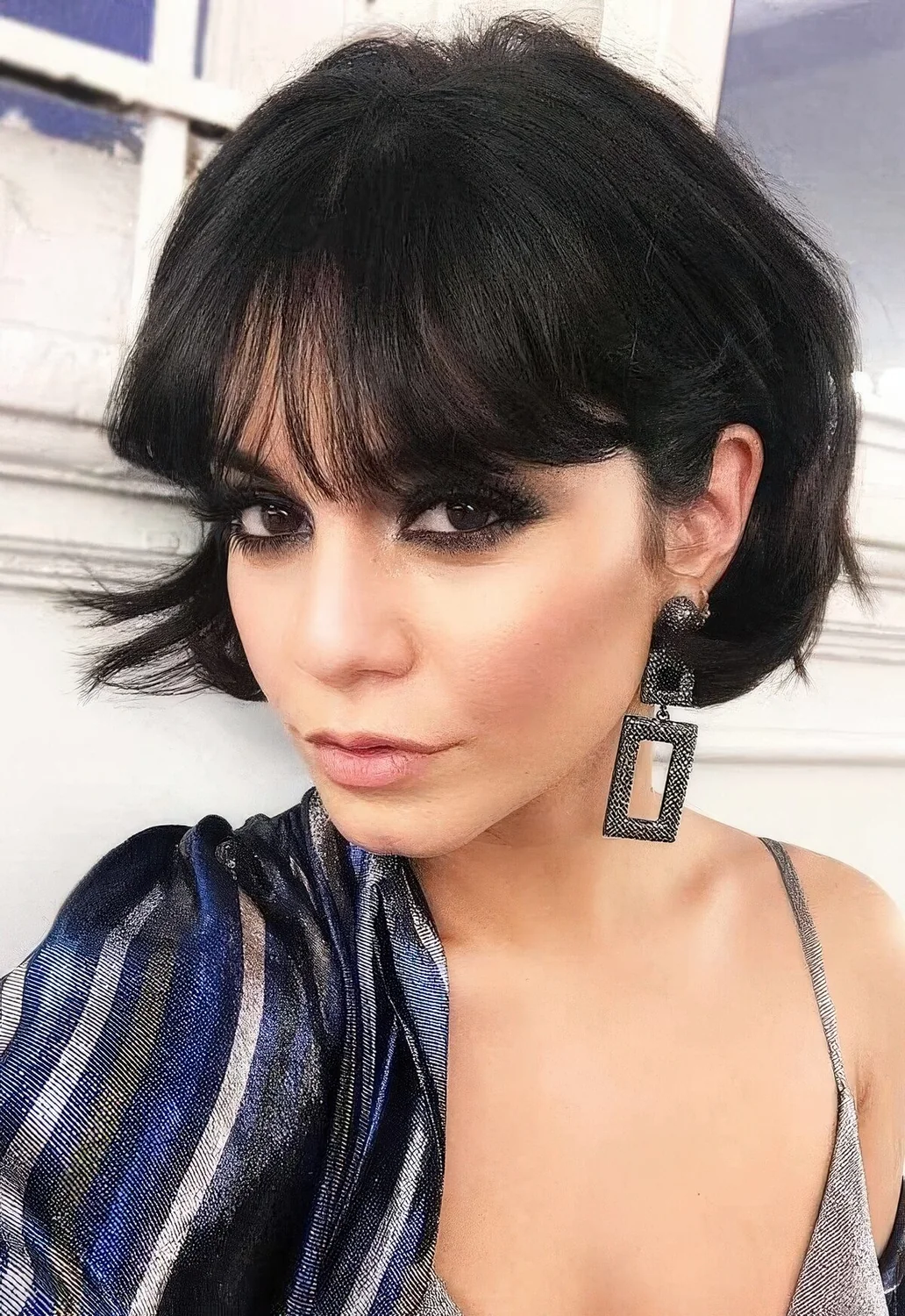 Short black bob with a lot of volume and fringe bangs.