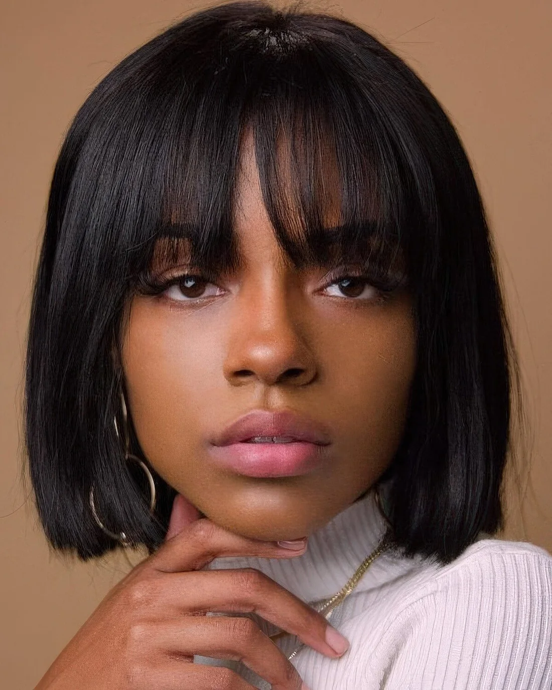 Short black bob with outgrown fringe bangs.