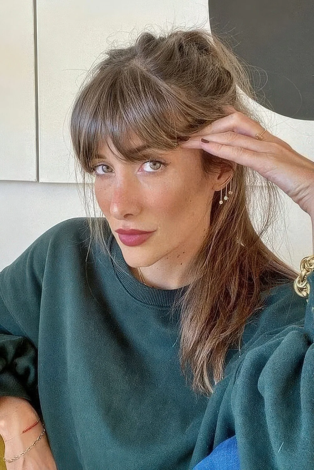 Long light brunette hair with a bit of texture and fringe bangs.