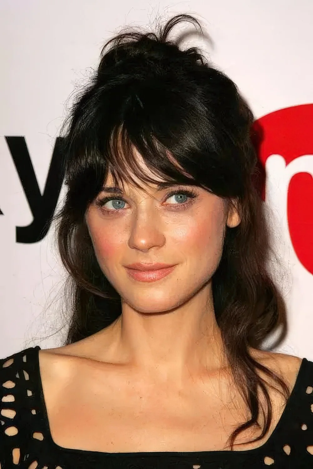 Rachel Zoe rocking a dark brunette updo with fringe bangs and some hair down.
