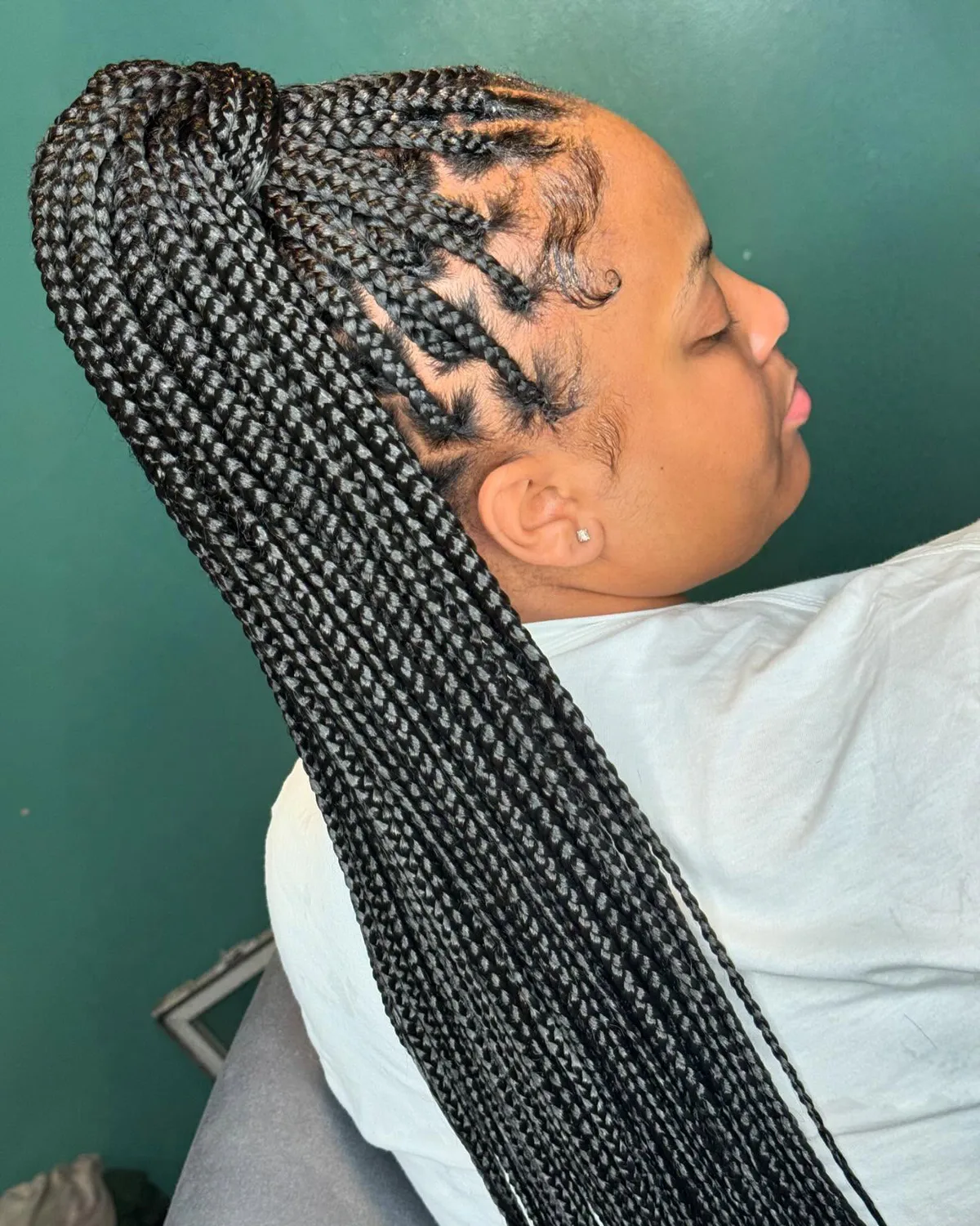 chest braids black knotless shown as a fulani braids idea, featuring black color, shown in black woman high braided ponytail