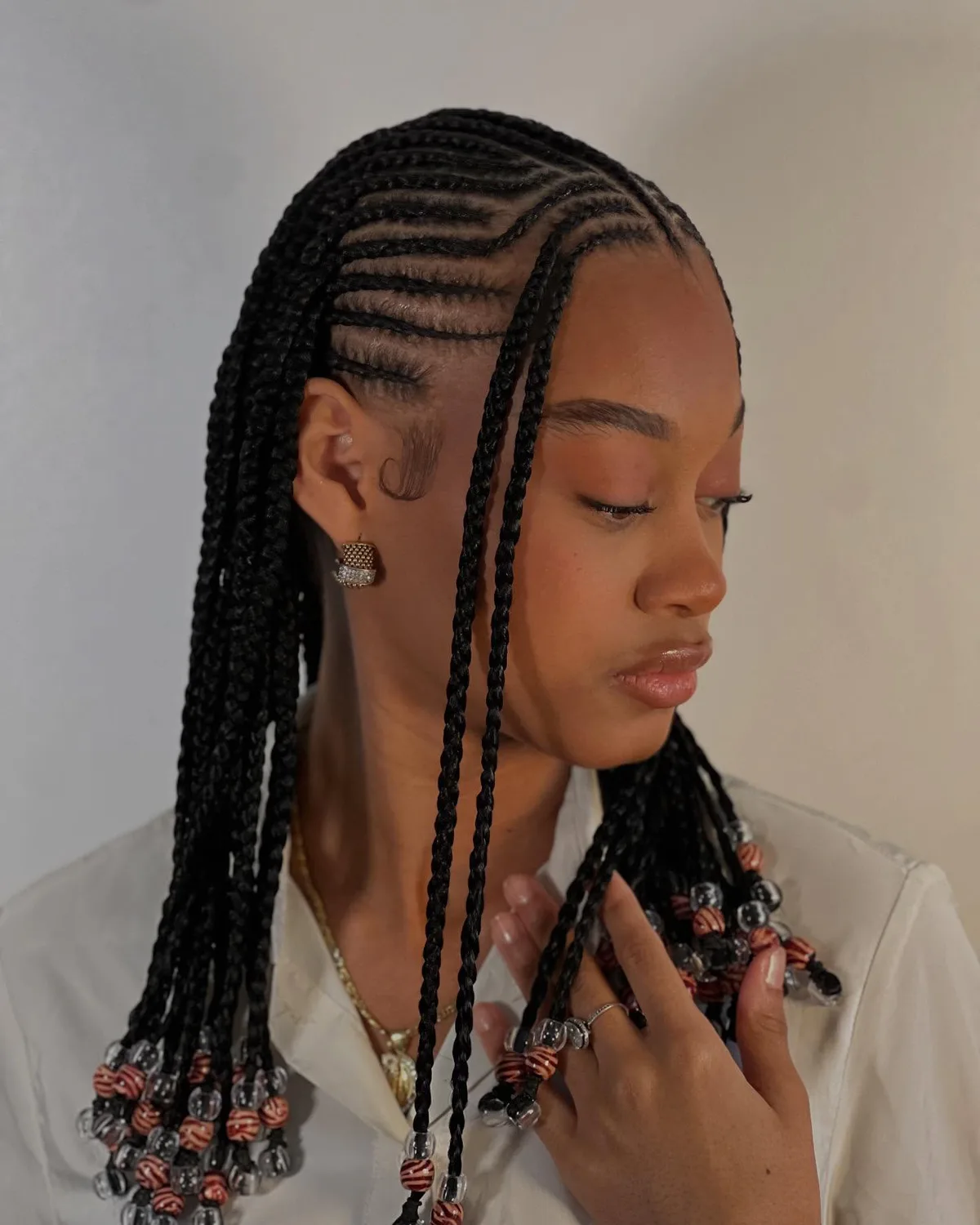 chest braids black knotless shown as a fulani braids idea, featuring chest outline, shown in black woman beaded fulani braids side view
