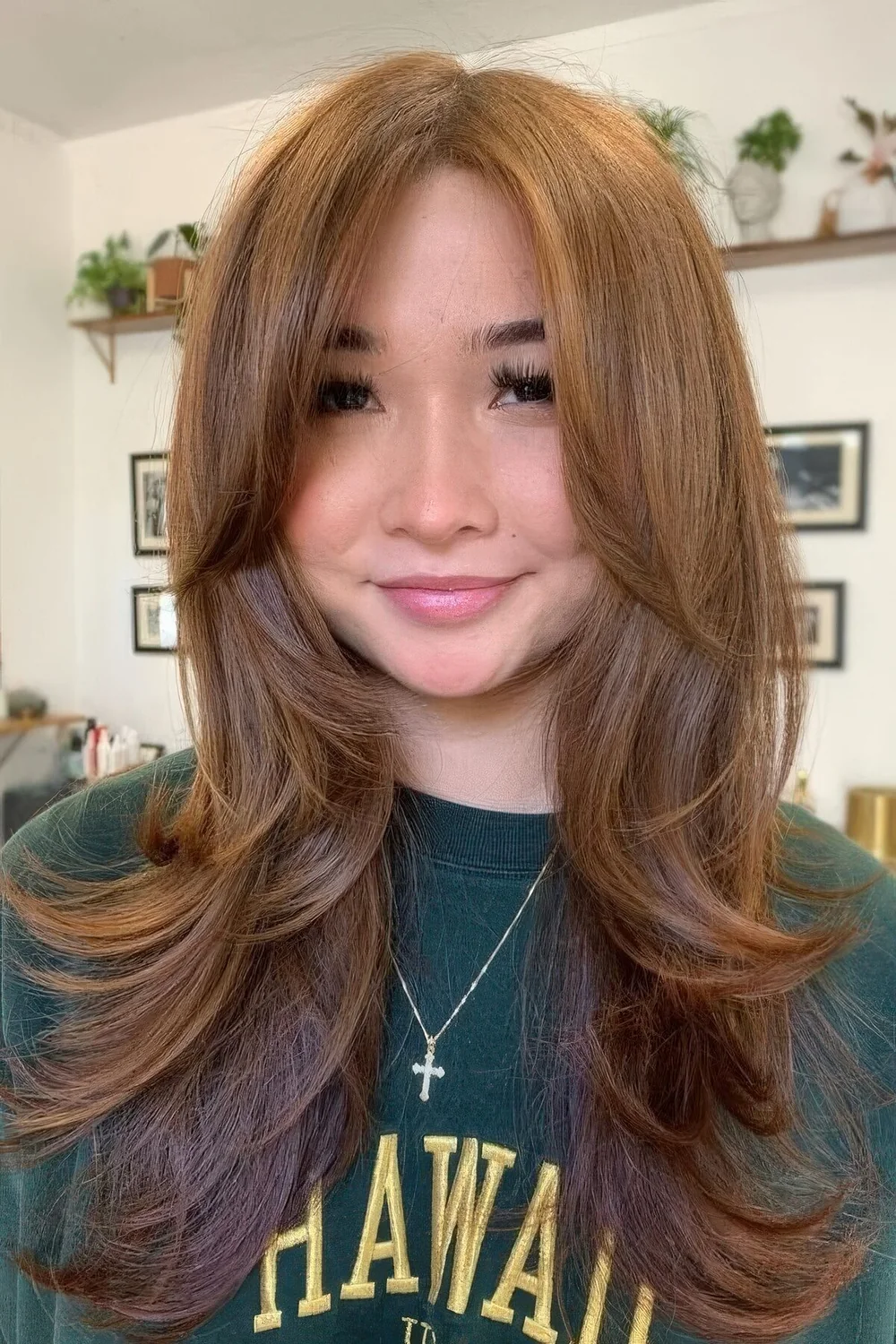 Ginger butterfly haircut with an ombre touch and long curtain bangs.