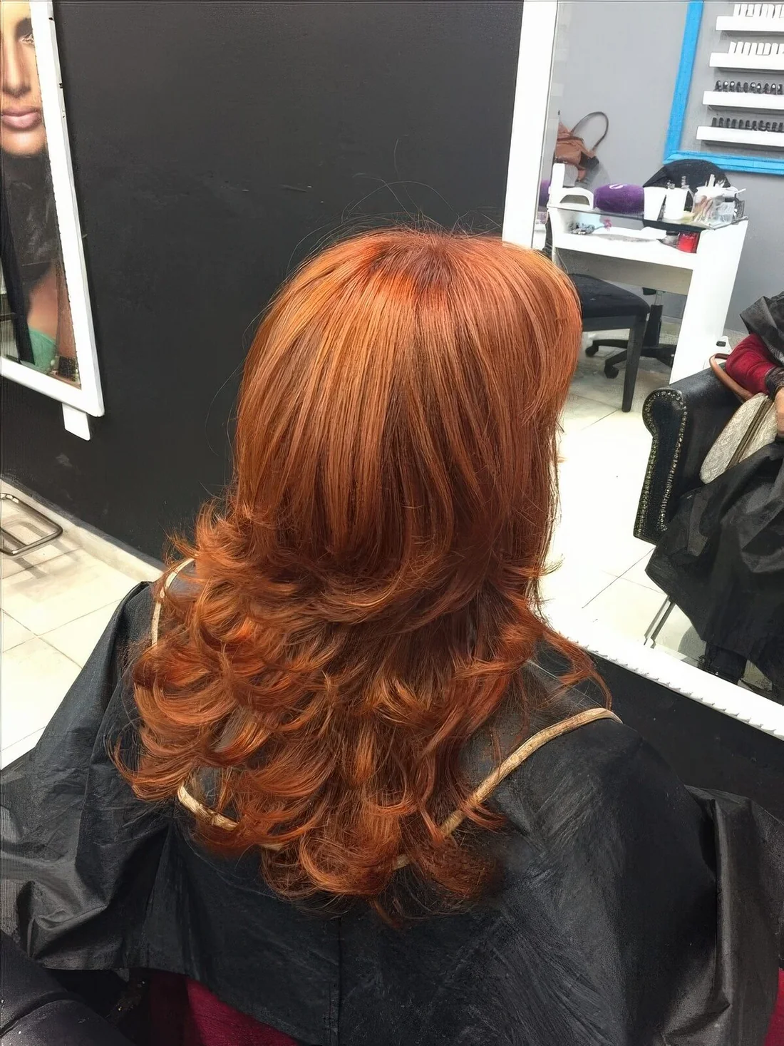 Bright and catchy copper butterfly haircut with curled ends and a lot of volume.