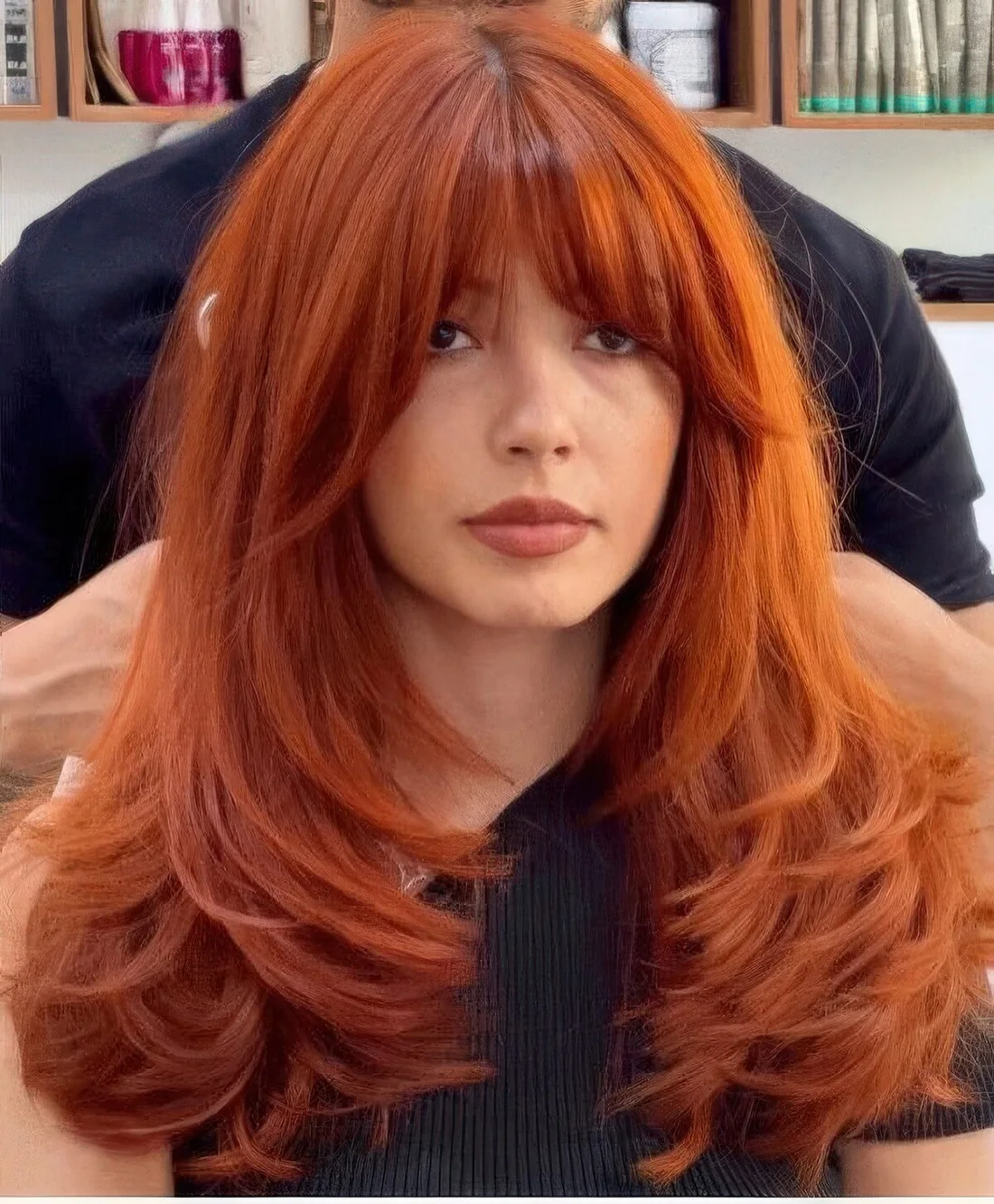 Jaw dropping red buttefly haircut with curtain bangs and lots of volume.