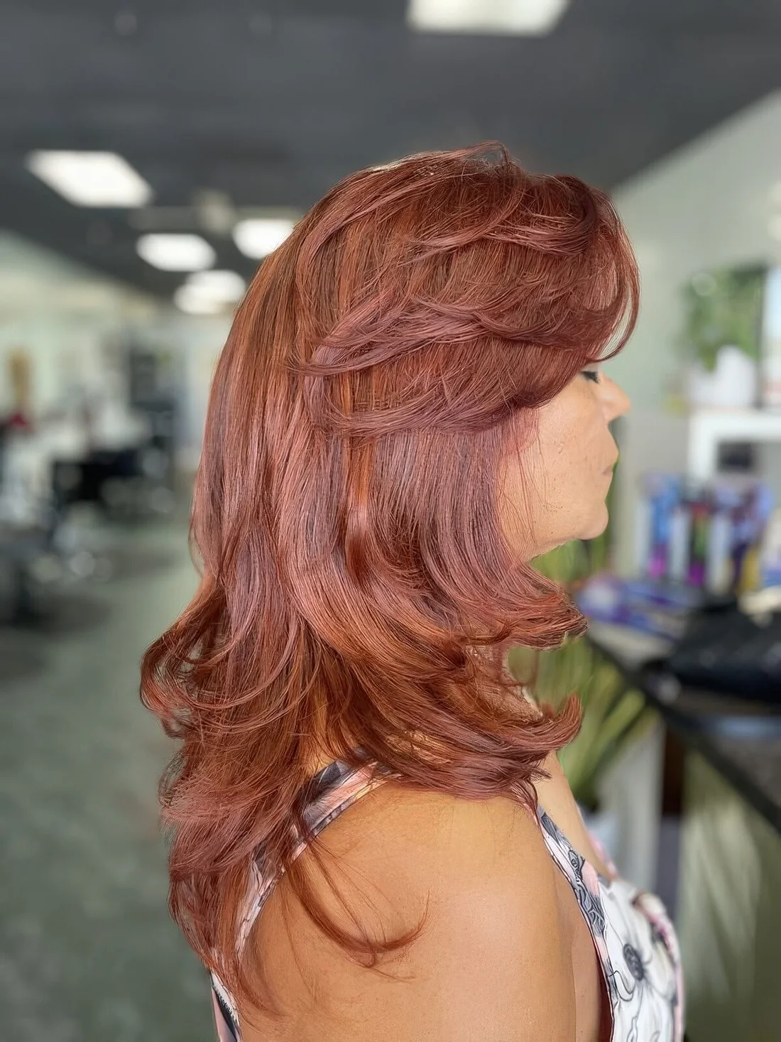 Bring a bolder touch to your look with such a bright hair color, a gorgeous butterfly haircut with a lot of volume and curled ends.