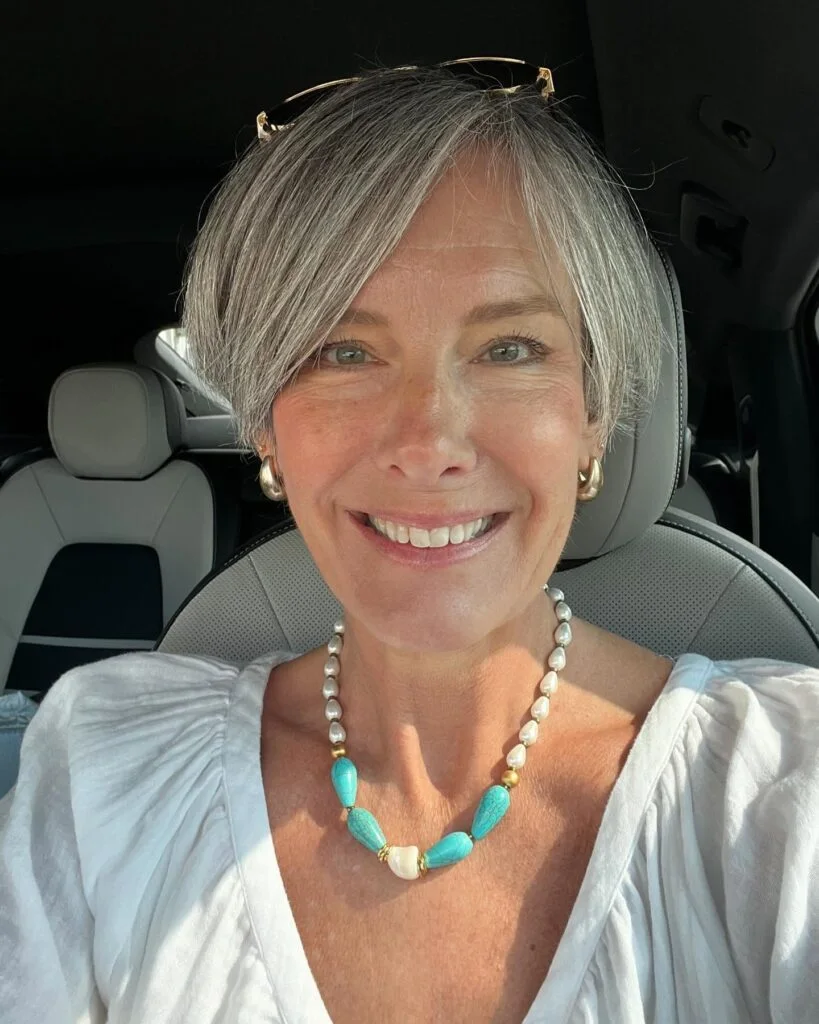 chin straight gray bob with side swept fringe shown as a gray blending for older women idea