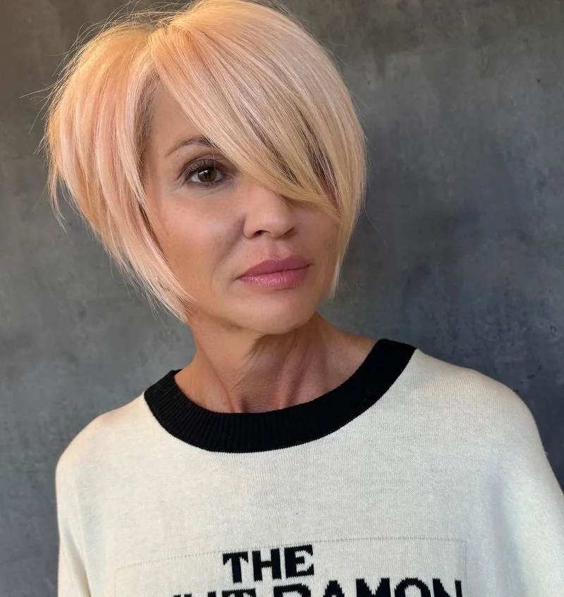 ear straight chestnut pixie with side swept fringe shown as a haircuts for thin fine hair idea, featuring side part