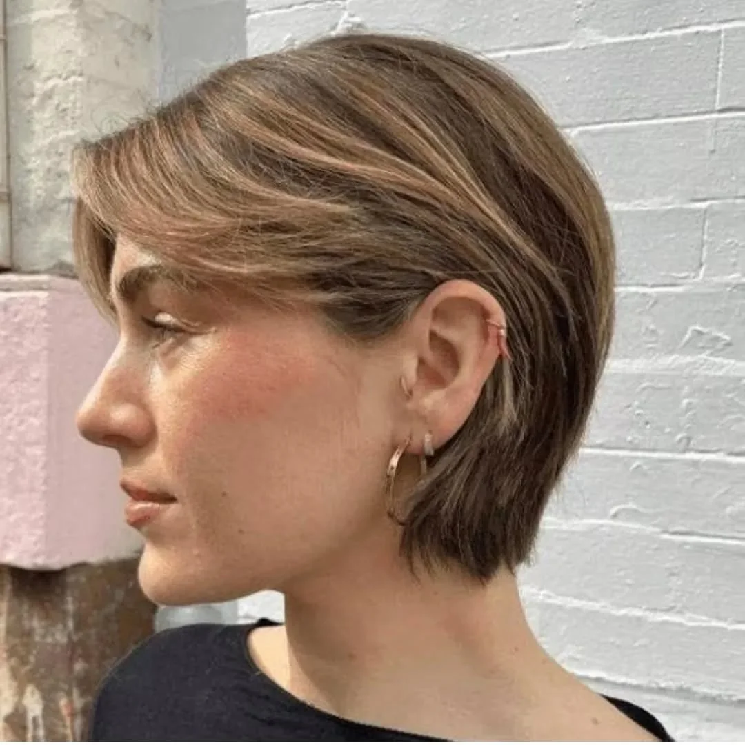 ear straight chestnut pixie with side swept fringe shown as a haircuts for thin fine hair idea, featuring straight texture