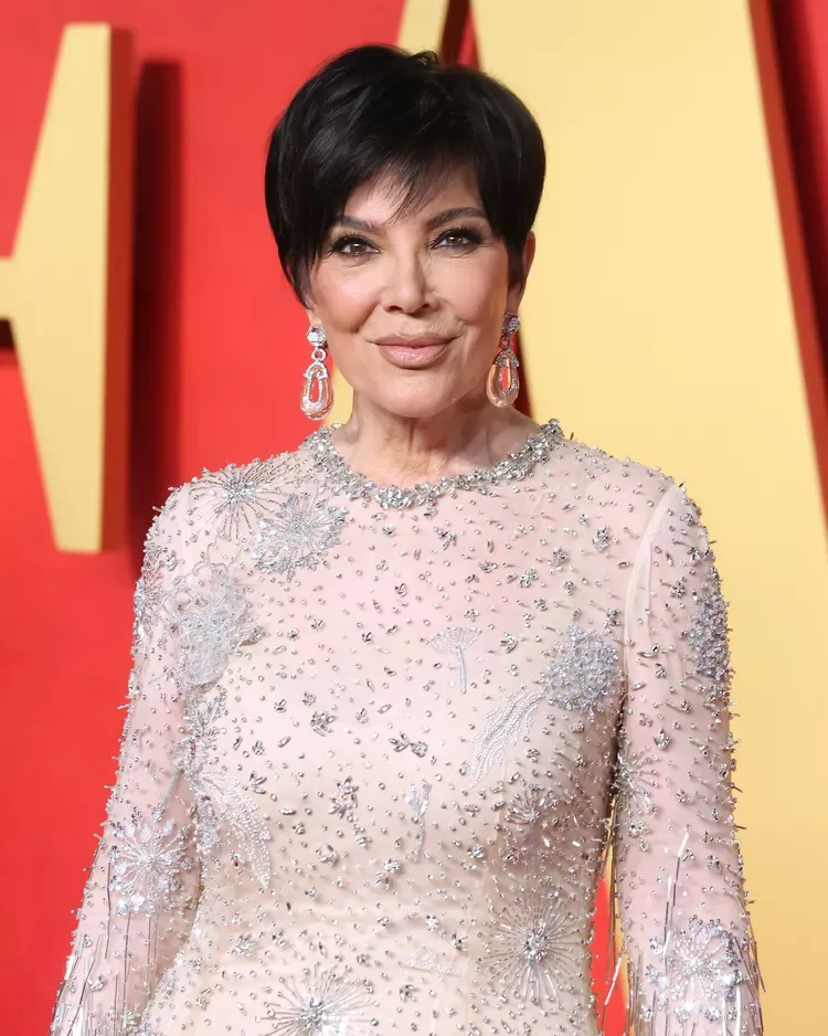 ear straight black pixie with side swept fringe shown as a haircuts for women over 50 idea