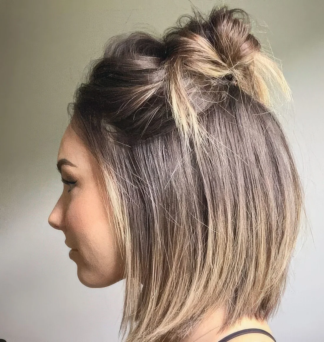 Long bob with a top knot and a messy bump on top.