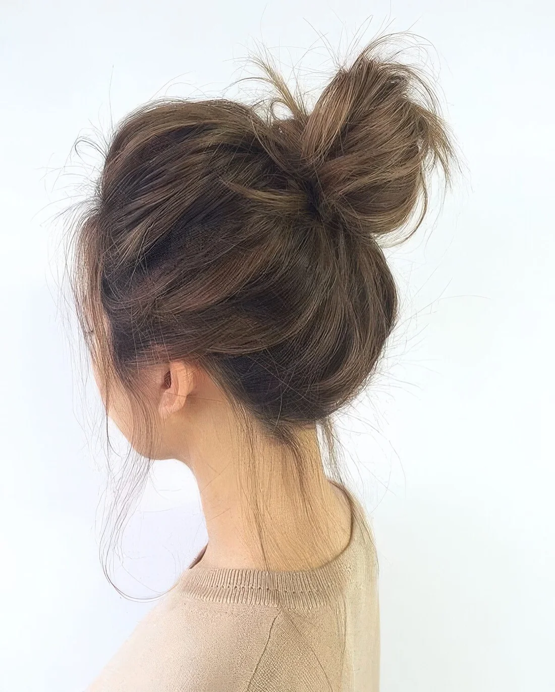 Messy top knot with a bump on top and down.