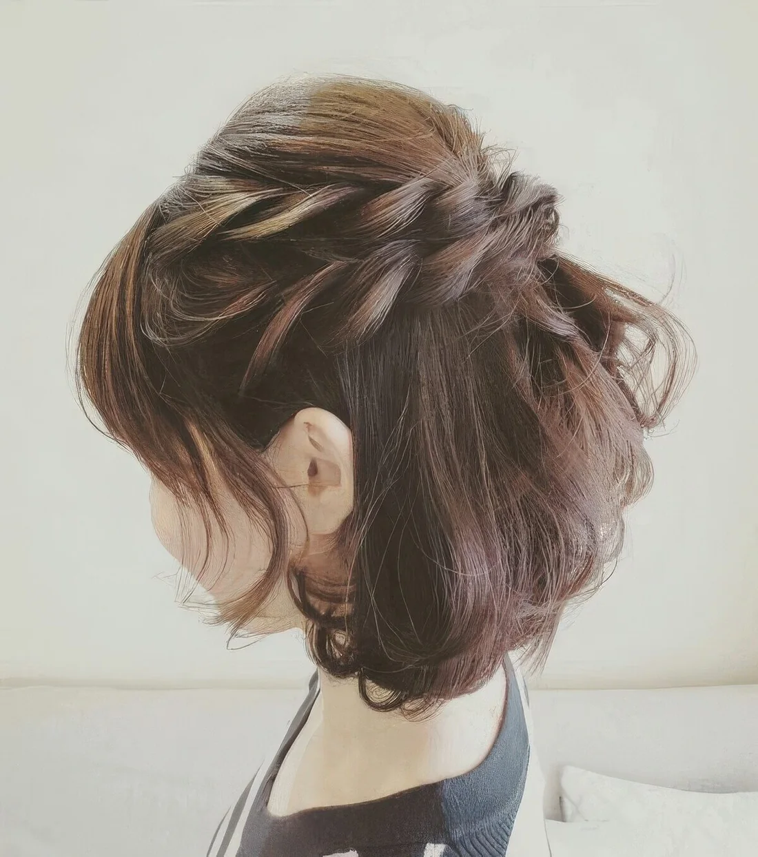 Half updo with a double braid and a bump on top plus a lot of volumetric hair.
