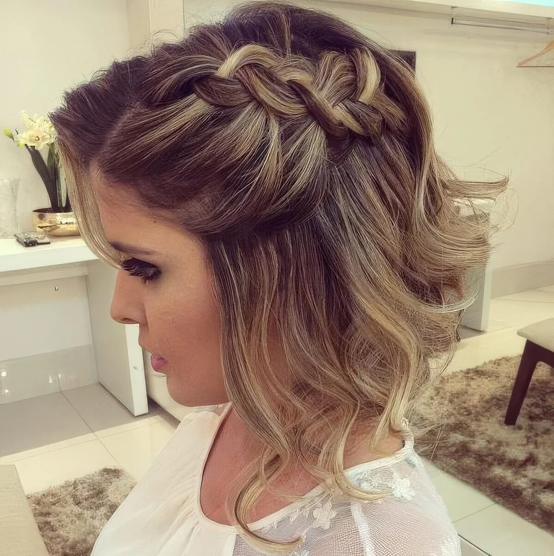 Wavy short hair with a large braid on one side for a chic lookat any party.
