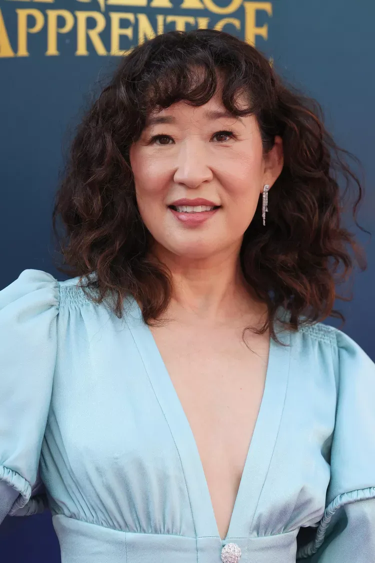 shoulder curly chestnut shag with curly fringe fringe shown as a hairstyles for women over 40 with bangs idea, featuring textured finish